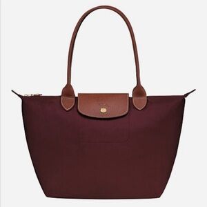 Longchamp le pliage foldable tote bag in burgundy.